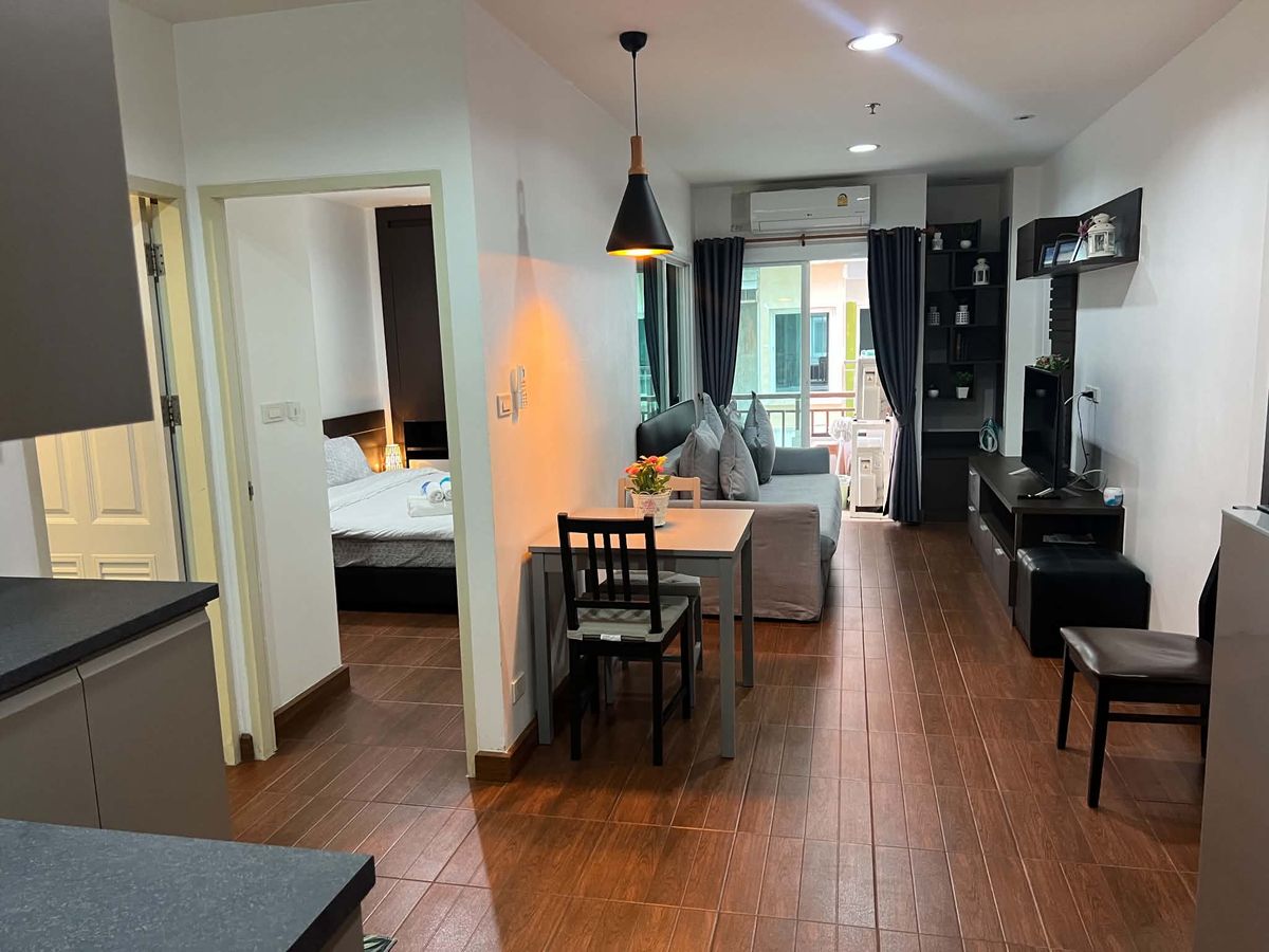 Living room with dining table, sofa bed and bedroom